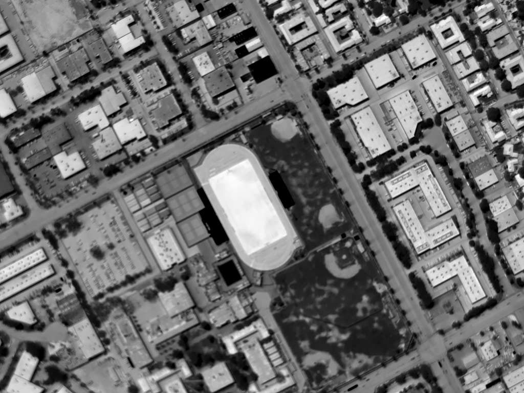 Daytime Aerial Thermograph of John North High School in Riverside, California. Ambient Air Temperature Approximated 105°F; The Apparent Temperature (AT) of the Synthetic Turf is Approximately 180°F; the Adjacent Natural Turf AT is Approximately 95, and the Infield Dirt Approximately 145°F.